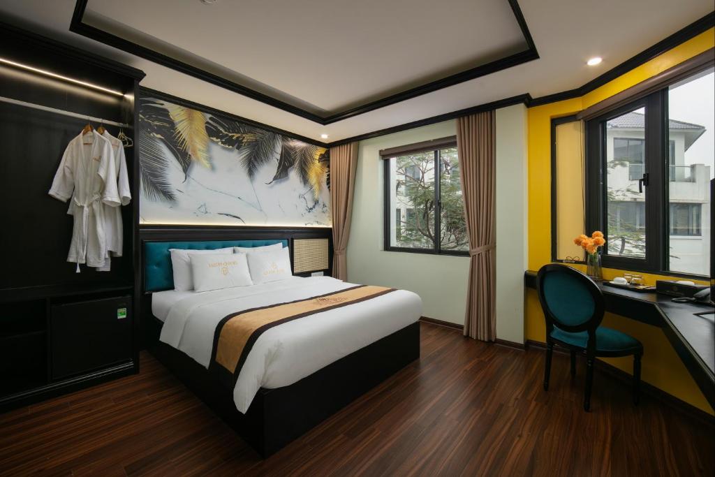 Postel nebo postele na pokoji v ubytování Grand Hanoi Hotel