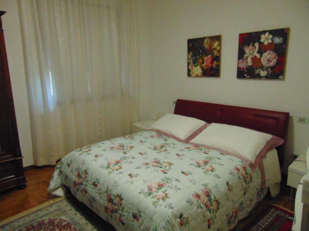 a bedroom with a bed with a floral bedspread at Podere Luma Camera Gelsomino - Lavanda in Gambassi Terme