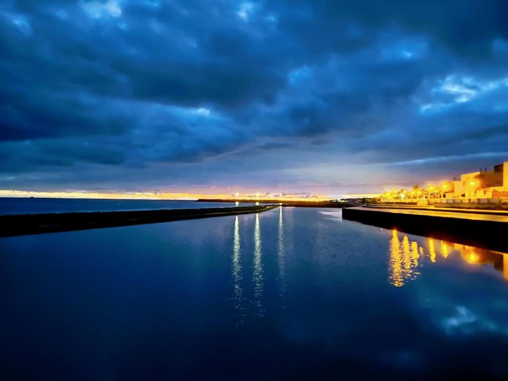 a view of a river at night with a cloudy sky at Apartamentos en Castillo del Romeral in Castillo del Romeral