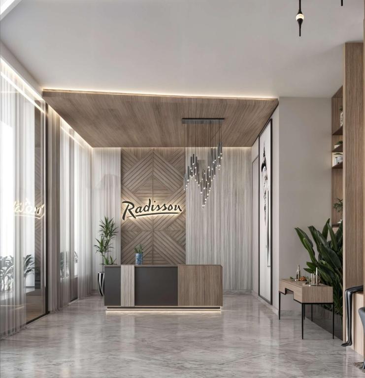 a lobby of a hotel with a reception desk at Radisson Hotel Jeddah Tahlia in Jeddah