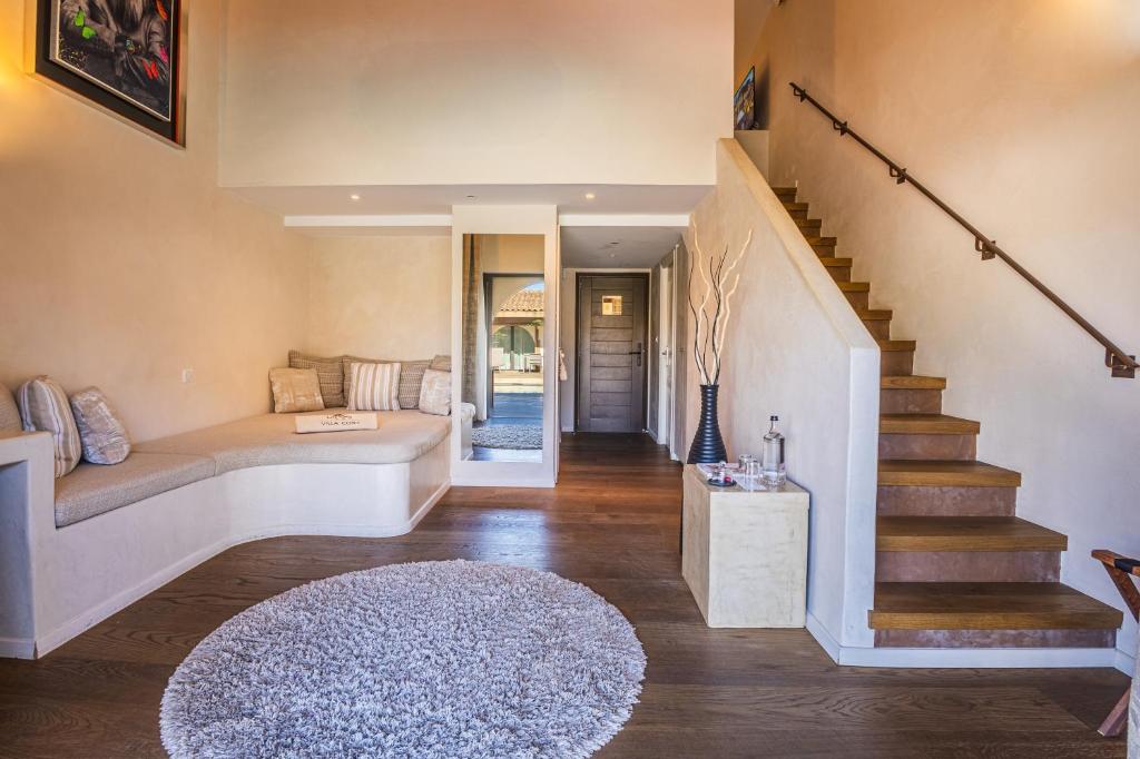 a living room with a couch and a staircase at Villa Cosy, hotel & spa in Saint-Tropez