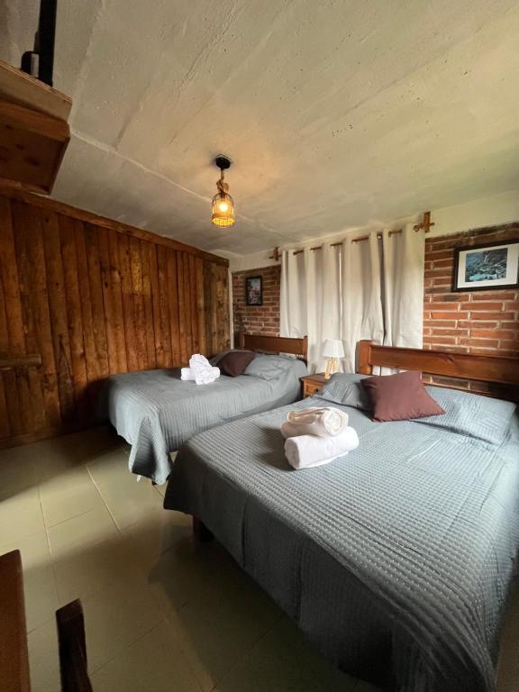 Postel nebo postele na pokoji v ubytování La Misión Cabañas Chignahuapan