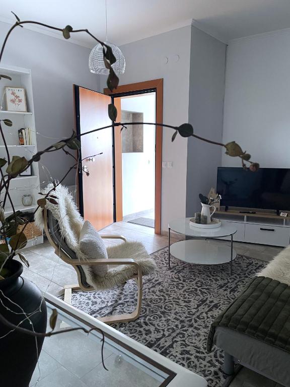 a living room with a couch and a chair at Zoe's House in Polykárpion