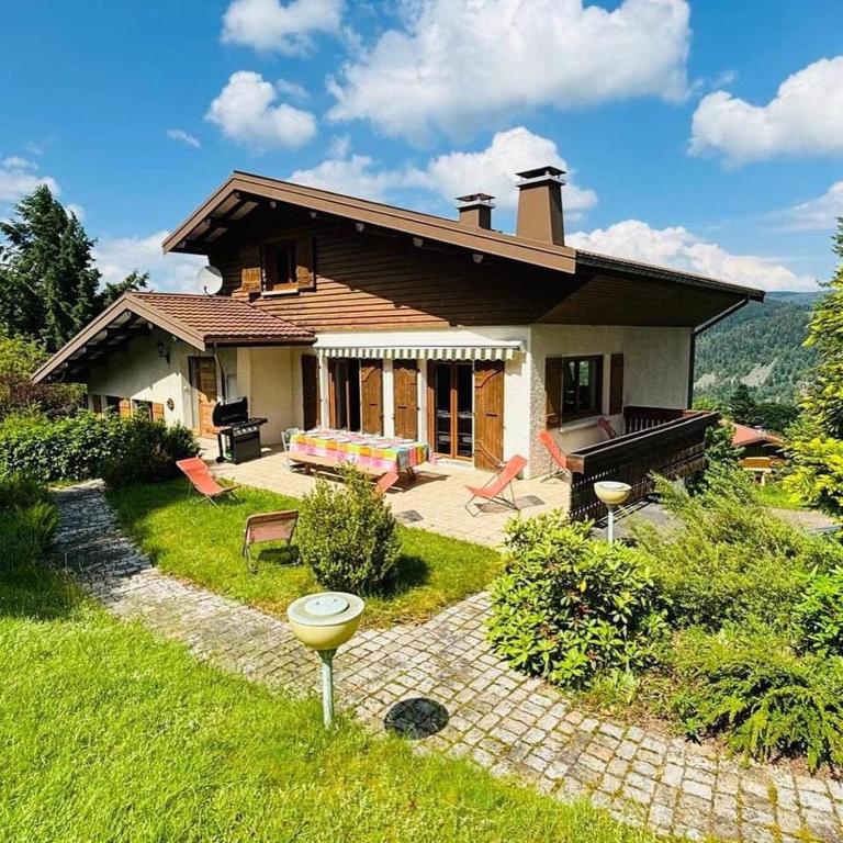 une maison avec un jardin devant dans l'établissement Le Vénérable, 4 étoiles, vue imprenable au coeur des Vosges, à Ventron