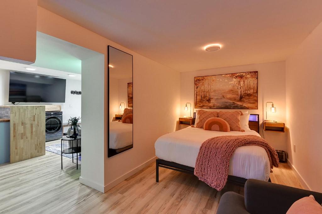 a bedroom with a bed and a living room at Modern Chic Retreat Luxe Comfort and Style in Omaha