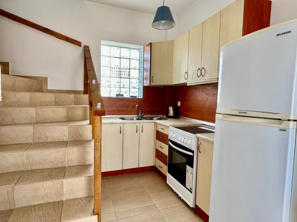 A kitchen or kitchenette at Michaella's Maissonete at Rafaella Resort