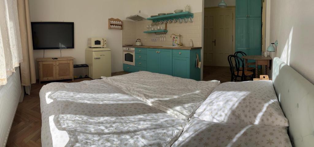 Postel nebo postele na pokoji v ubytování Apartmány Naxarův dvůr