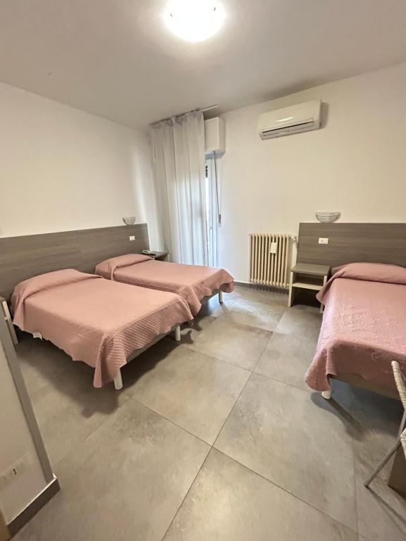 Postel nebo postele na pokoji v ubytování Hotel Marchina