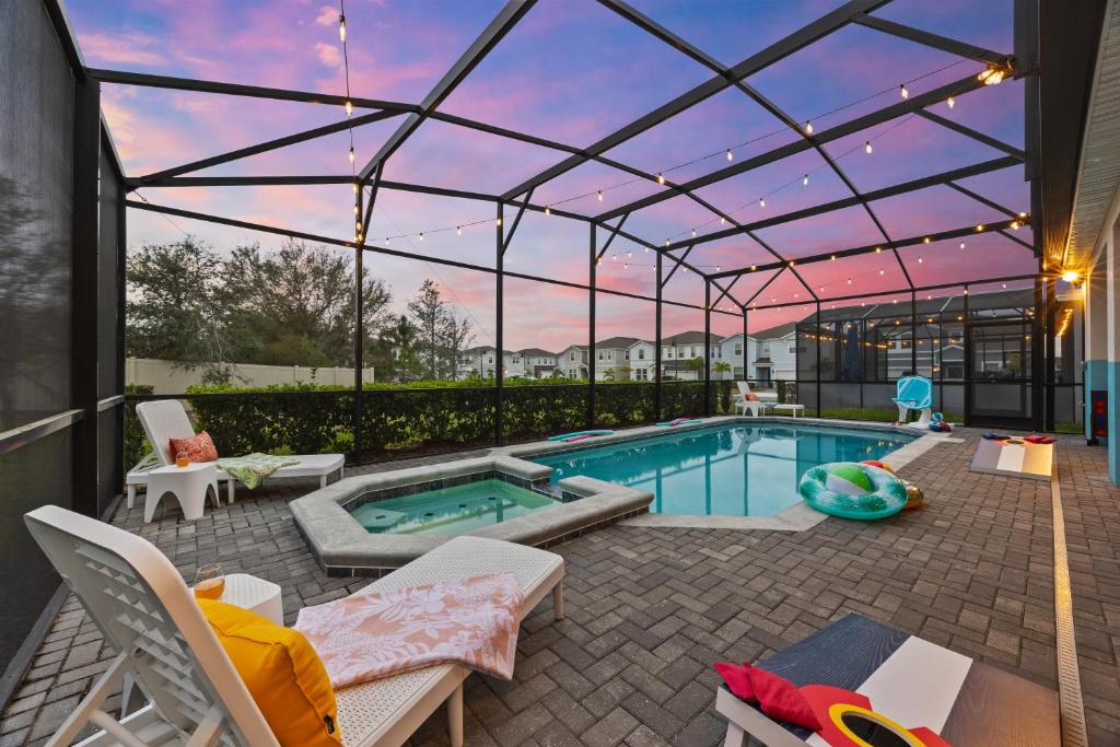 a swimming pool with a retractable roof at The Orlando Oasis in Davenport