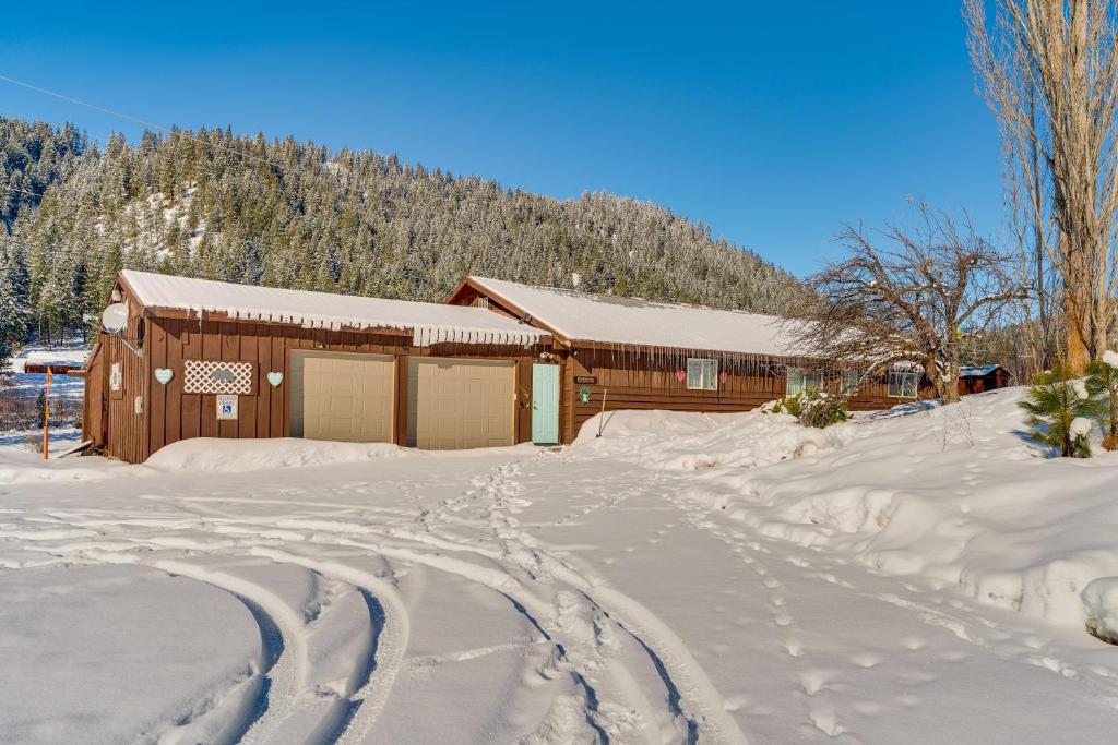 a house in the snow with tracks in the snow at Tranquil Ranch Home on 10 Acres in Leavenworth! in Leavenworth