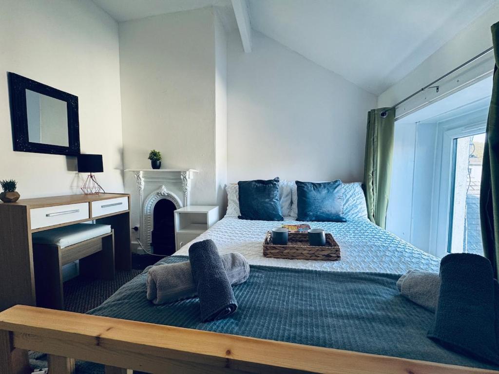a bedroom with a bed with a table on it at Harrington House - 6 Bedrooms - Sleeps 15 in Workington