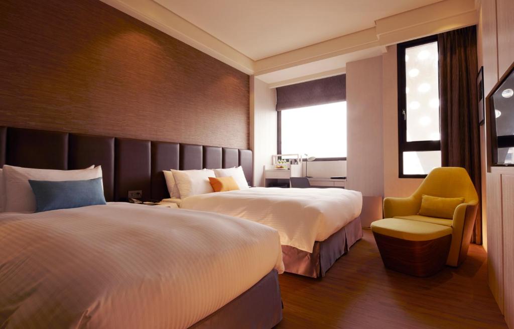 Postel nebo postele na pokoji v ubytování Treeart Hotel