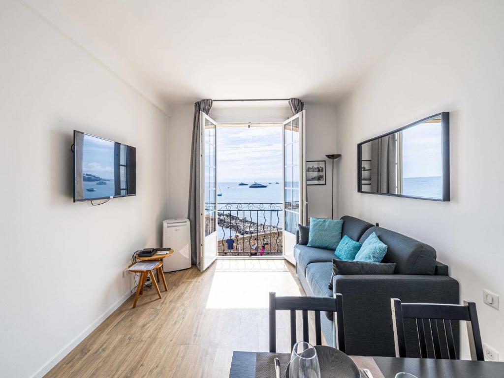 un salon avec un canapé et une vue sur l'océan dans l'établissement Charming Appt - 1BD 4P- sea view - Antibes Centre, à Antibes