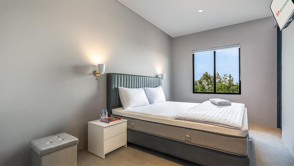 a small bedroom with a bed and a window at Swiss-Belexpress Rest Area KM 260B in Bulakamba