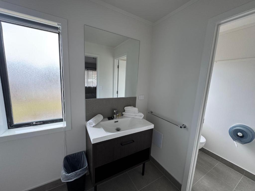 Postel nebo postele na pokoji v ubytování Grosvenor Motel
