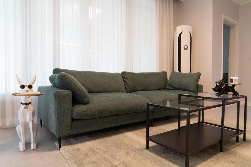a living room with a green couch and a table at Manoa Garden in Seoul