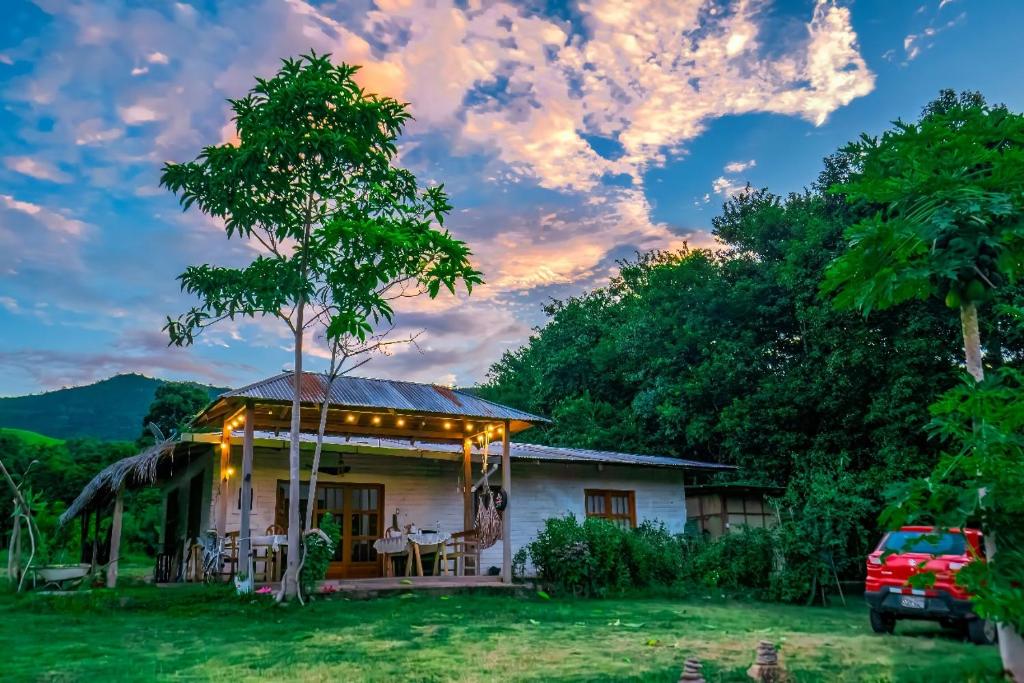 a house with lights on the front of it at Villa Patricia - Tres Unidos in Tres Unidos