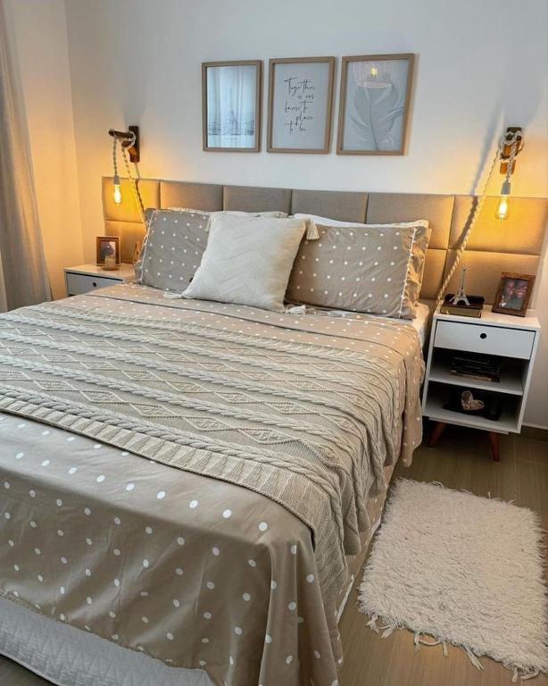 a bedroom with a large bed in a room at Edifício Vista Verde in Valença