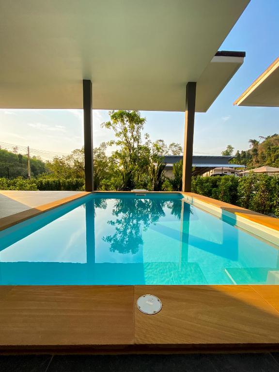a swimming pool in the middle of a house at Hornbill Pool Villas 1 in Ko Chang