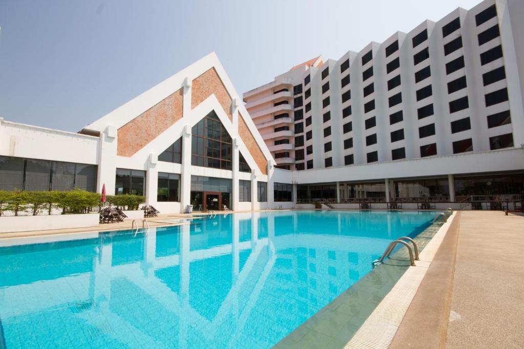 a large swimming pool in front of a building at Rimpao Hotel in Kalasin