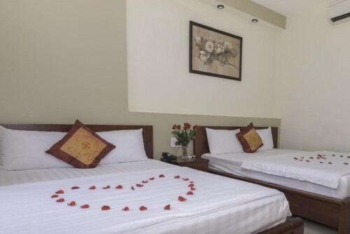 Postel nebo postele na pokoji v ubytování Smile hotel