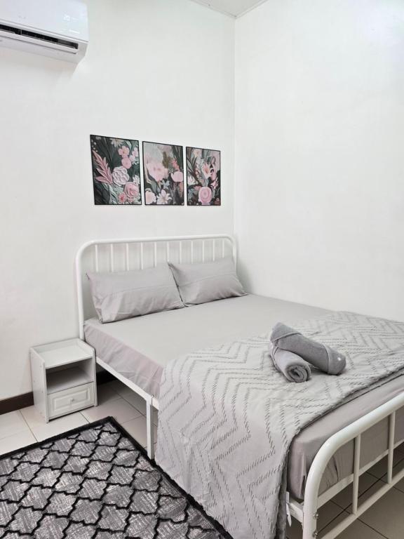 a white bed in a white room with a white wall at INNAS Homestay in Seksyen 7, Shah Alam in Shah Alam