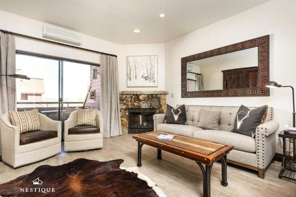 a living room with a couch and a fireplace at LMV A-107 in Park City