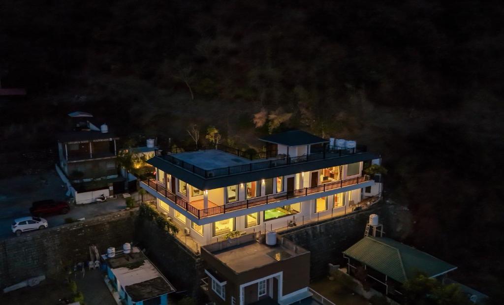 an overhead view of a house with a blue roof at SaffronStays Glasscape in Dehradun