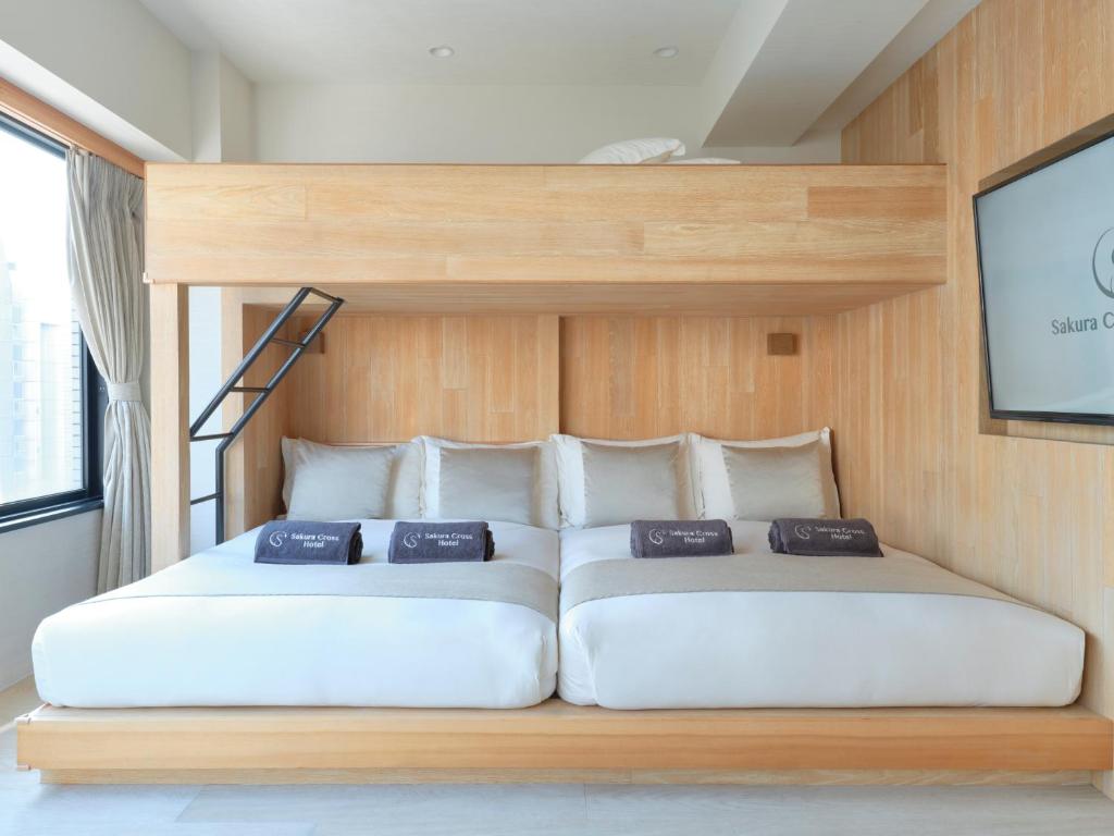 Postel nebo postele na pokoji v ubytování Sakura Cross Hotel Akihabara