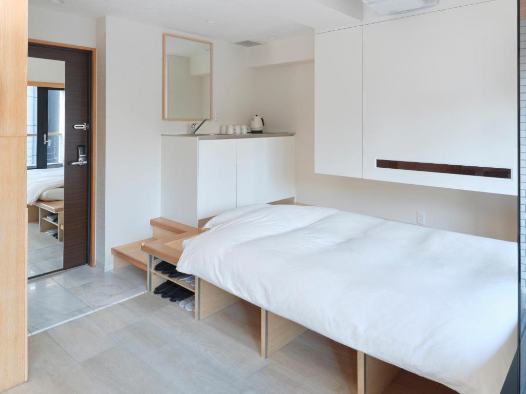 Postel nebo postele na pokoji v ubytování Sakura Cross Hotel Akihabara