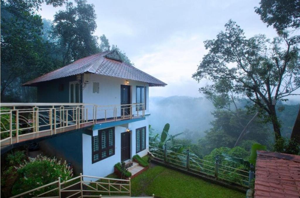 a house on a hill with a view at Lazo Golden Valley Resort , Munnar in Munnar