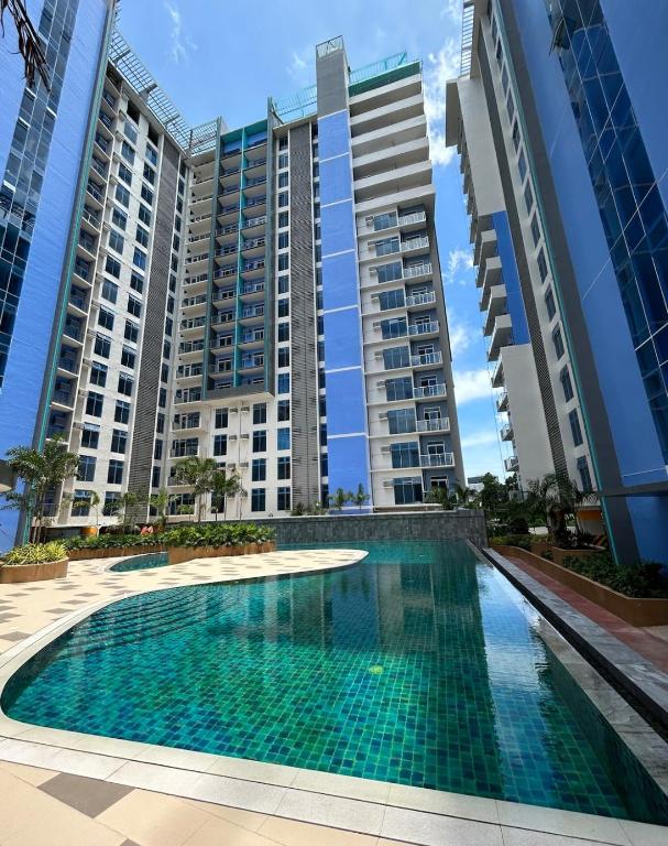 a swimming pool in front of two tall buildings at Mivela Residences in Cebu City