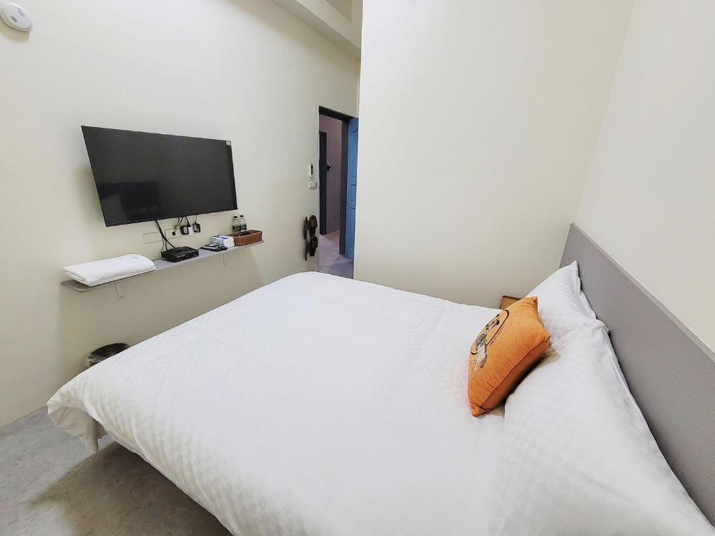 Postel nebo postele na pokoji v ubytování 幸運草輕旅