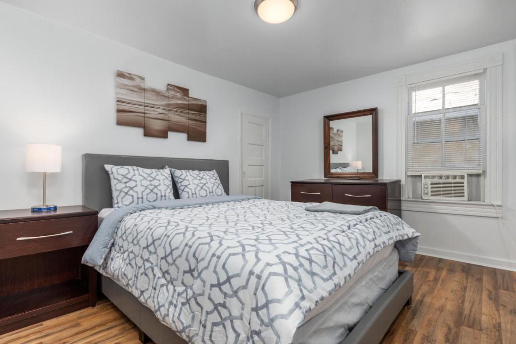 a white bedroom with a bed and a window at Somerset 2 in Ocean City