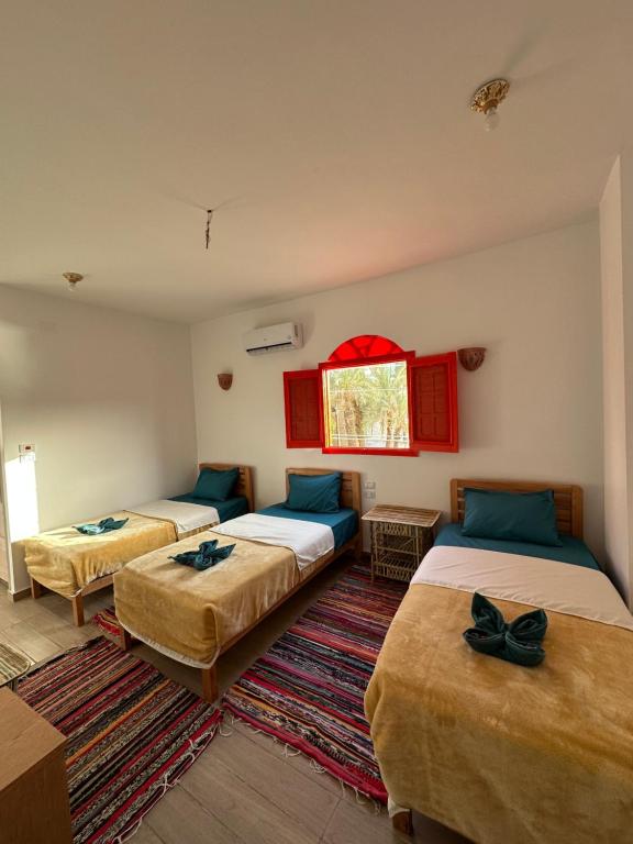 Postel nebo postele na pokoji v ubytování Palm Geust House