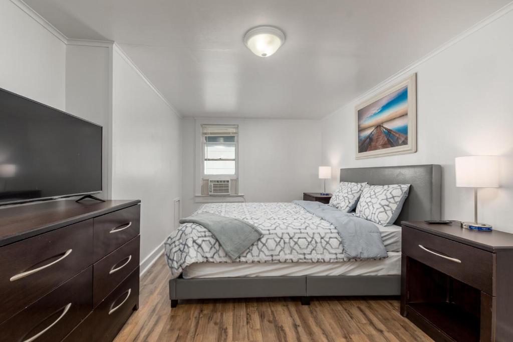a bedroom with a bed and a flat screen tv at Somerset 4 in Ocean City
