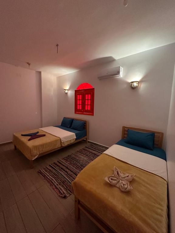 Postel nebo postele na pokoji v ubytování Palm Geust House