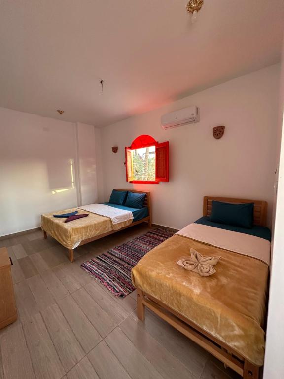 Postel nebo postele na pokoji v ubytování Palm Geust House