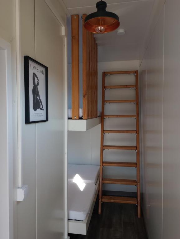 a bathroom with a sink and a stair case at TinyHouses & Garden in Oravská Poruba