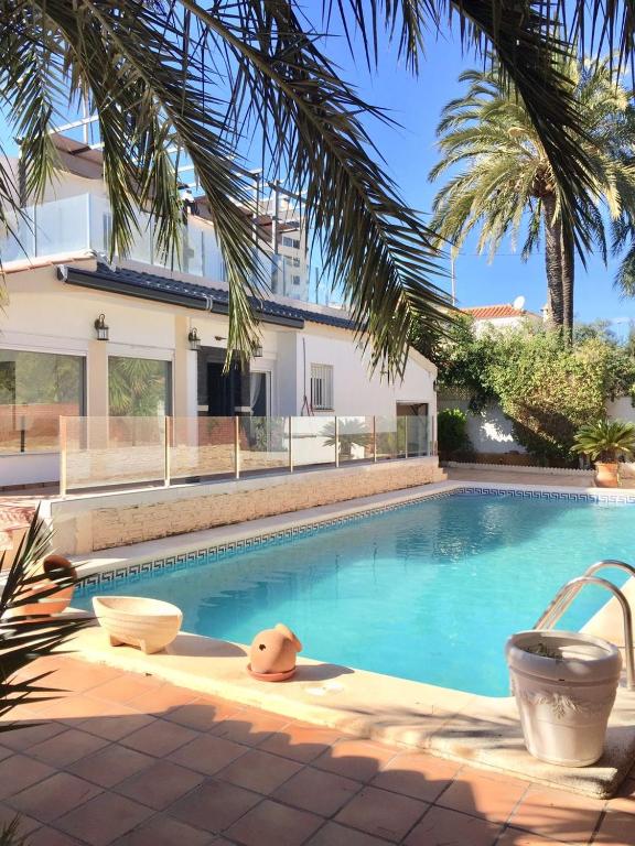 a swimming pool in front of a house at VILLA San Juan PLAYA Alicante in El Campello