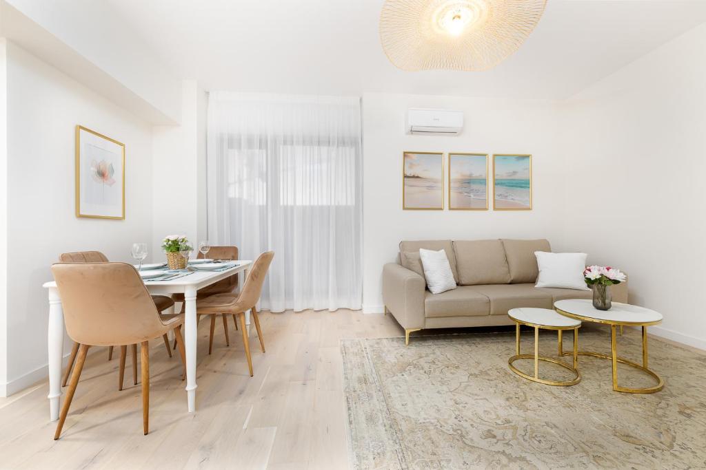 a living room with a couch and a table at First Estates Apartment 2BR in Voluntari