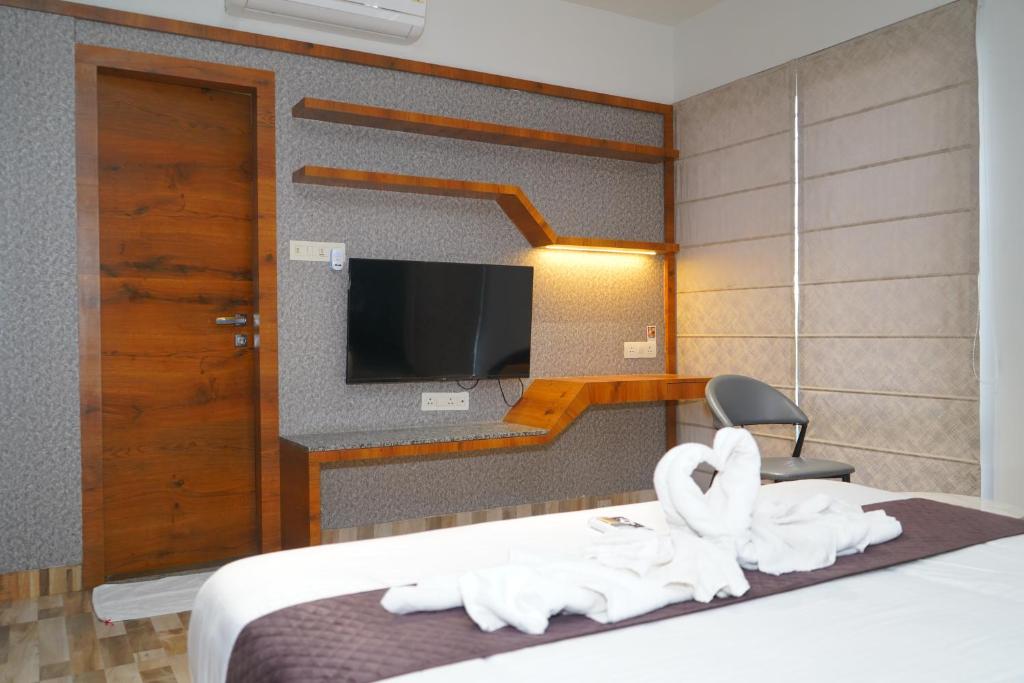 Postel nebo postele na pokoji v ubytování Abssolute Homtel - Rooms & Suites