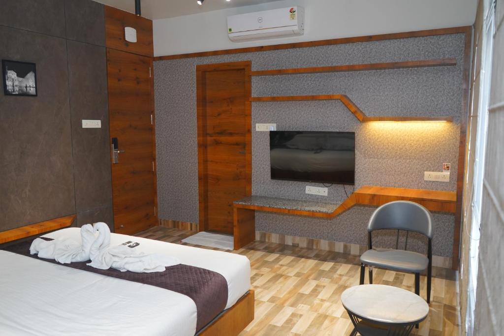Postel nebo postele na pokoji v ubytování Abssolute Homtel - Rooms & Suites