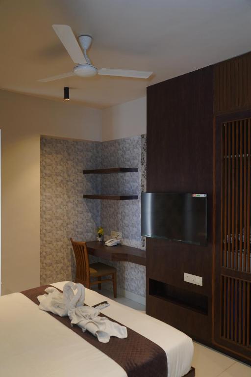 Postel nebo postele na pokoji v ubytování Abssolute Homtel - Rooms & Suites