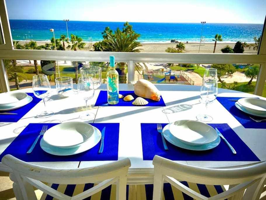 a dining table with a view of the beach at Apartamento Sea View By Solymar Holiday in Torre del Mar
