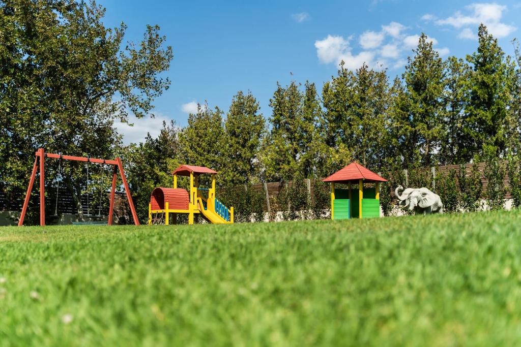 a playground with two play equipment in a field at Plaza Resort in Anavyssos