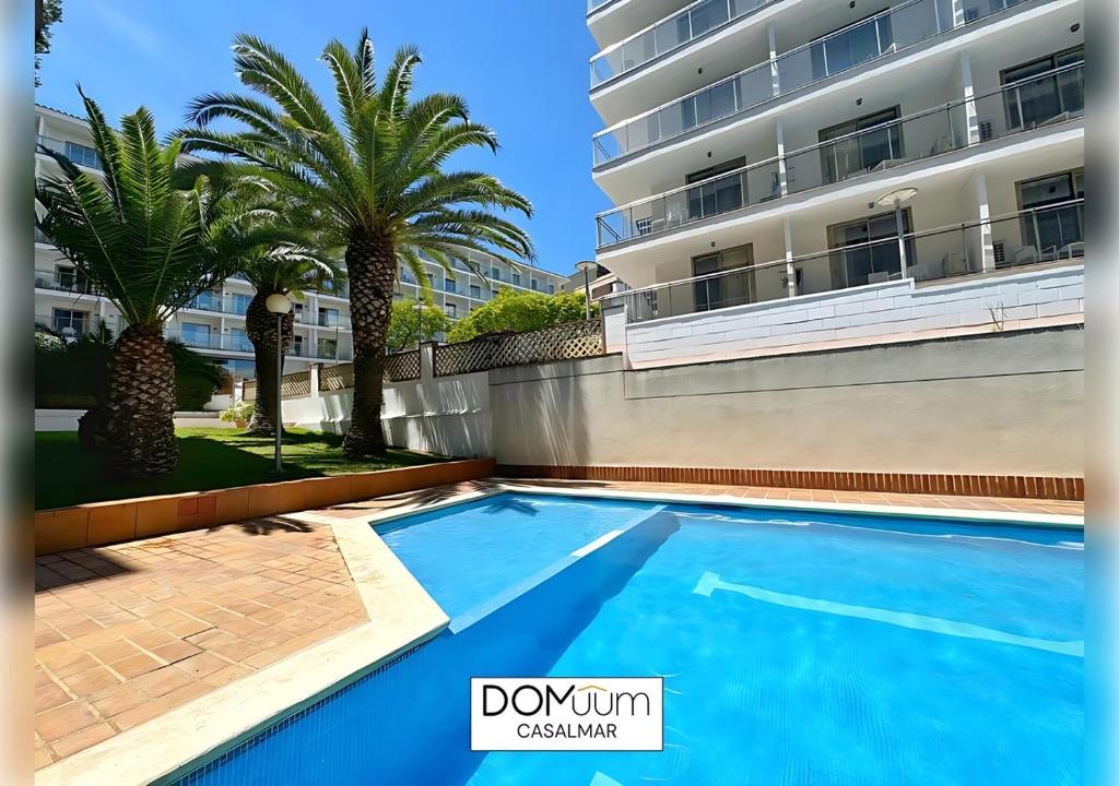 a swimming pool in front of a building at DOMuum Holidays -CASALMAR Family Home in Salou