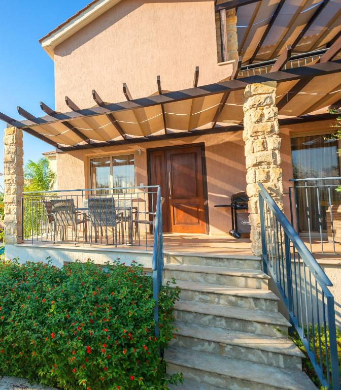a house with a staircase leading to a porch at Villa Samaliana Sandy Beach Villas - Private Pool - Jacuzzi - Private Beach Area in Polis Chrysochous