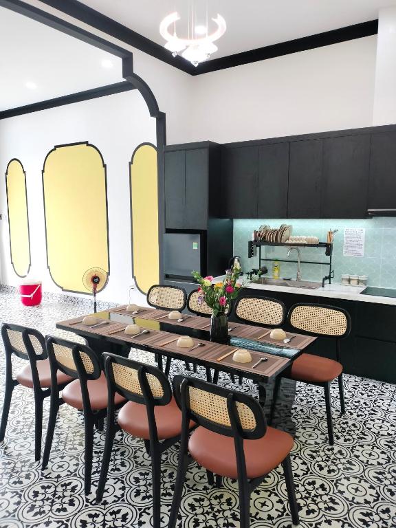 a dining room with a table and chairs at Villa RonRoy Hà Tiên in Hà Tiên