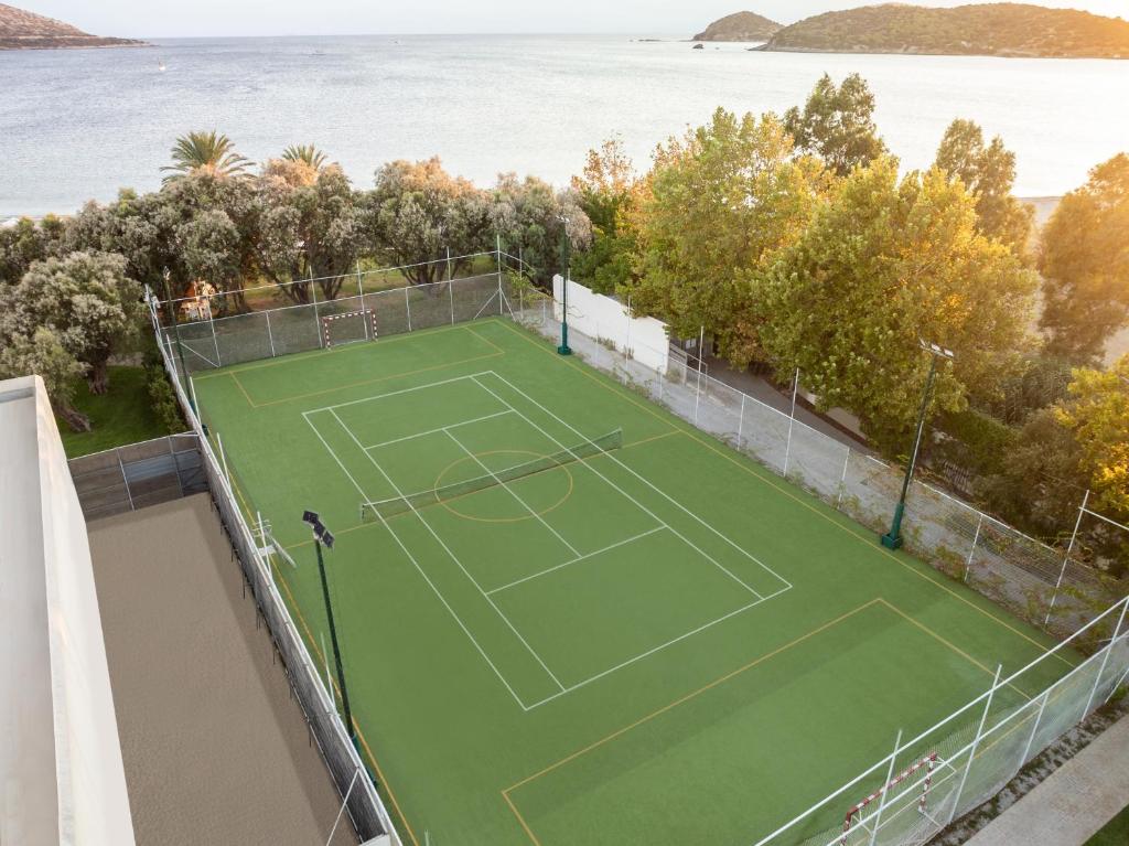 an aerial view of a tennis court with the ocean at Plaza Resort in Anavyssos